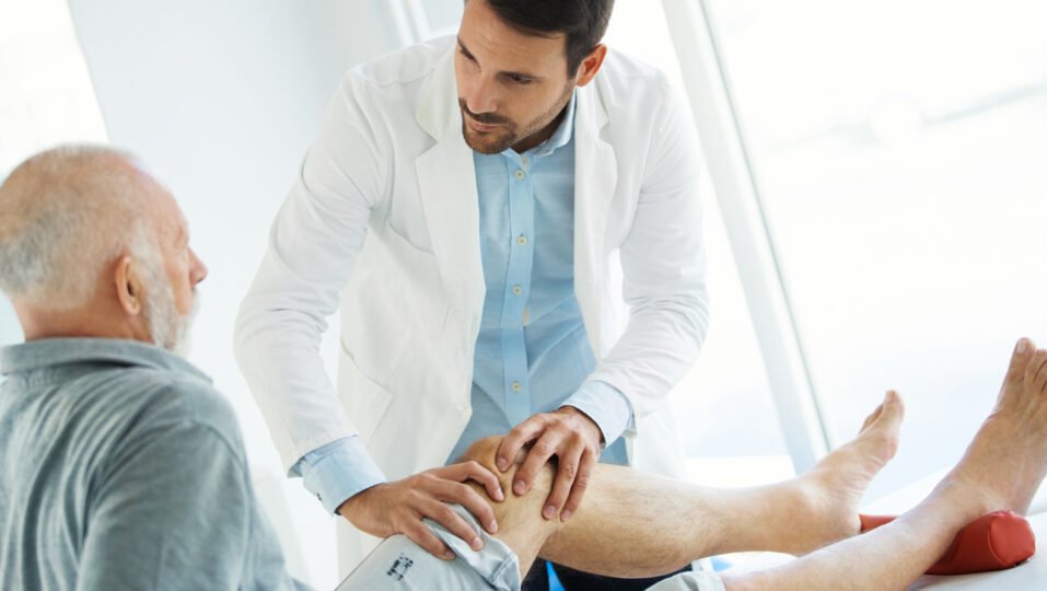 Doctor examining a patient's knee